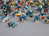 toy figurines of the smurfs are lined up on a table
