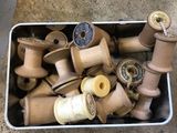 many spools of thread and spools in a container