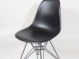 black plastic chair with wire legs and a black seat