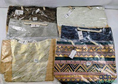 four bags of different colors and designs on the table