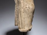 a white marble head of a woman on a wooden stand