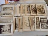 a lot of old books on a table with pictures on them