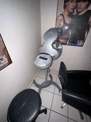 a chair and a stool in a room with a poster on the wall