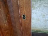 a close up of a wooden door with a keyhole on it