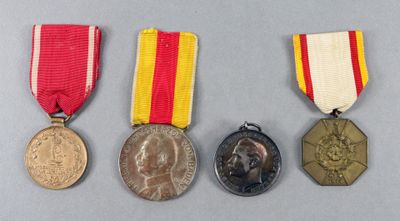 three medals and a medal on a gray surface
