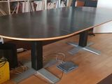 a black table with a wooden top in a room