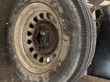 a tire that is sitting on the ground next to a wheel
