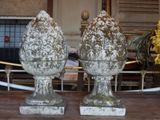 two vases sitting on top of a table next to each other