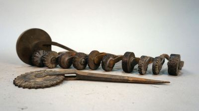 a lot of screws and a pair of scissors on the table