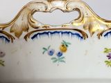 a white bowl with blue and yellow flowers on it