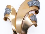 an image of a gold and diamond broochle on a white background