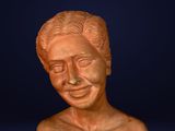 a close up of a bust of a man on a blue background