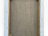 an image of a picture frame on a wall with a piece of fabric