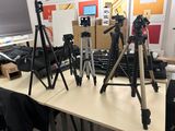many tripods sitting on a table in a room