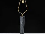 a black marble table lamp with a gold metal base and a black shade