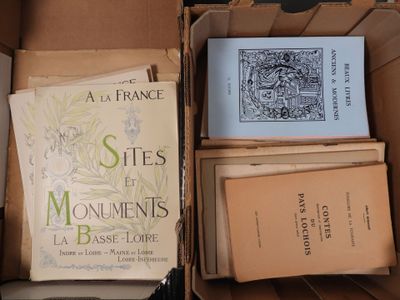 several books are in a box on top of a table