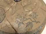 an image of a stone box with a design on it