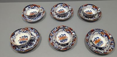 six tasses et une soucoupe posées sur une table