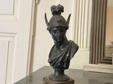 a statue of a woman with a crown on top of a table