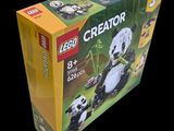 a box of lego creator pandas sitting on a black surface