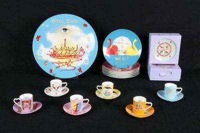 a lot of tea cups and saucers sitting on a table