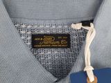a close up of a blue shirt with a tag on it
