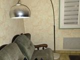 an image of a living room with a couch and a lamp