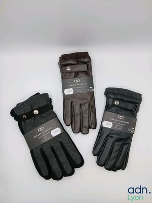 three pairs of black gloves on a white surface