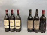 six bouteilles de vin sont alignées sur une table