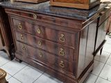 a dresser with a clock on top of it in a room