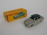 a toy car that is sitting next to a box