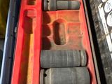 a red box with tools in it on a table