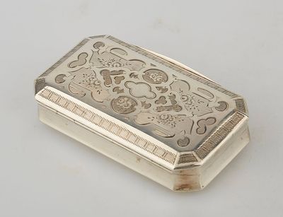 an antique silver cigarette case on a white surface
