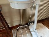 a white toilet sitting on top of a cart in front of a window