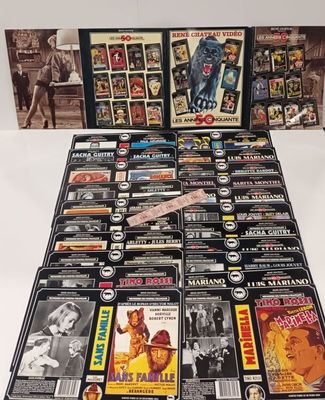 a large collection of movies and dvds on display on a table