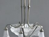 a chandelier with five glass shades hanging from the ceiling