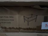 packaging of a bed frame in a box with a price tag on it