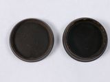 pair of black and brown bowls on a white surface