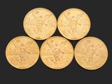 quatre souverains d'or, dont l'un est orné d'une tête ailée et l'autre d'une tête ailée