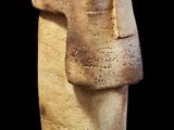a stone statue of a man ' s face on a black background