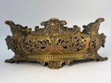 an antique brass bowl with ornate design on a white background