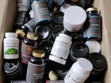 a cardboard box full of jars and jars of food