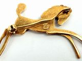 brass plated brooch depicting a horse with a long tail