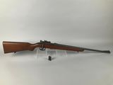 a rifle with a wooden barrel and a scope on a white background
