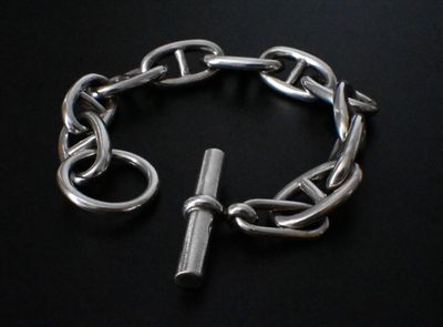 silver chain bracelet with a clasp on a black background