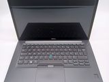 a laptop that is open on a white surface