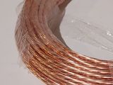 a coil of copper wire on a white surface