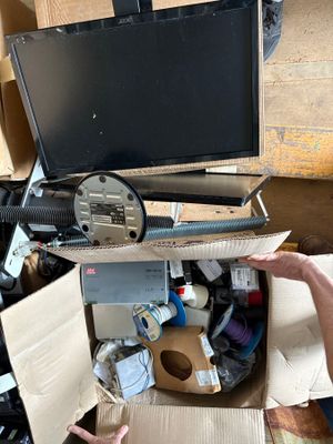 a man that is opening a box with a computer in it