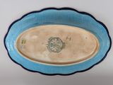 a blue and white plate with a picture of a dog on it