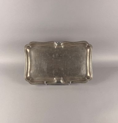 an antique silver tray on a white background with a silver handle